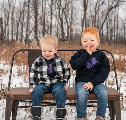 two brothers with hunter syndrome sitting on a bench